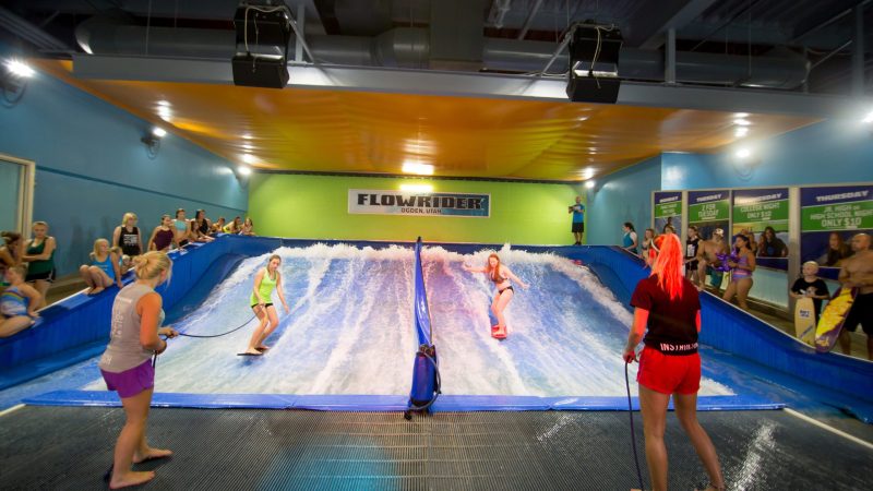 girls flowboarding at Flowrider