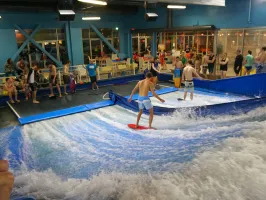 people watching two boys flowboard