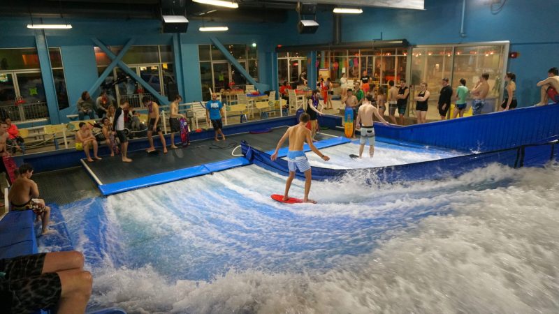 people watching two boys flowboard