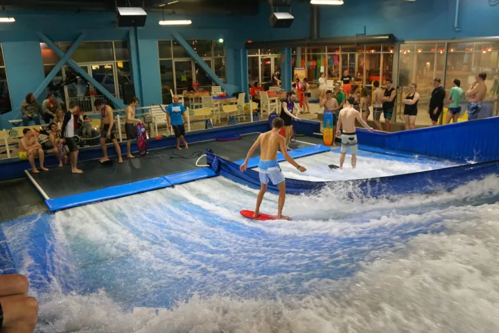 people indoor surfing at Flowrider