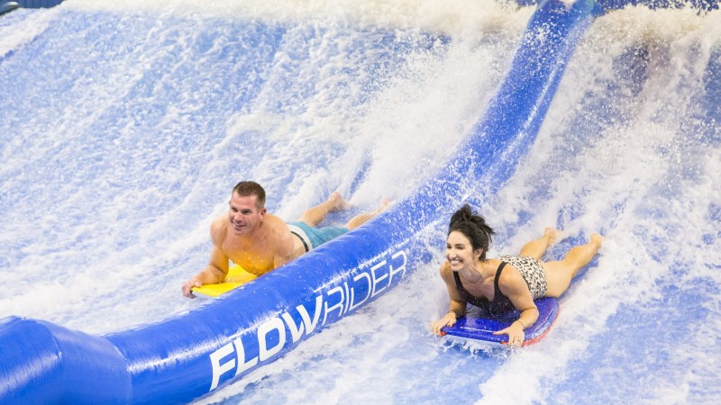 two people bodyboarding at Flowrider